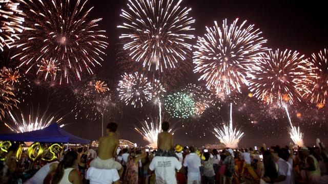 La foule assiste au feu d'artifice tiré à Rio de Janeiro. [Keystone/EPA - Marcelo Sayao]