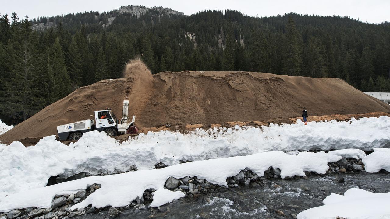 La montagne de neige artificielle (ici, à Davos) est recouverte d'une protection pour passer l'été. [Keystone - Christian Beutler]