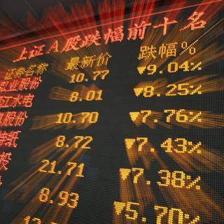 Un tableau électronique de la Bourse de Shanghai montre l'indice monter. [keystone - WU HONG]