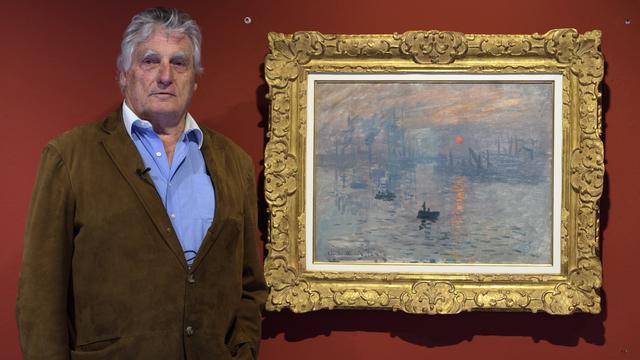 Léonard Gianadda pose devant "Impression, soleil levant" de Monet en 2017. [Keystone - Laurent Gilliéron]