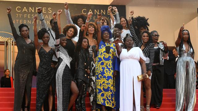 French actress Eye Haidara, French actress Maimouna Gueye, French director Magaajyia Silberfeld, French actress and producer France Zobda and French actress Sabine Pakora, (C fromL) French writer Rachel Khan, French actress and Miss France 2000 Sonia Rolland, French actress Aissa Maiga, French-Portuguese actress Sara Martins, French actress Firmine Richard, (front from L) French actress Assa Sylla, French actress Karidja Toure, French comedian and humorist Shirley Souagnon and French-Cameroonian Marie-Philomene Nga, some of the 16 black women who fight for equality and inclusion of black women in the French film industry pose on May 16, 2018 with Burundian singer and member of the Feature Film Jury Khadja Nin (C) as they arrive for the screening of the film "Burning" at the 71st edition of the Cannes Film Festival in Cannes, southern France. [AFP - Loic Venance]