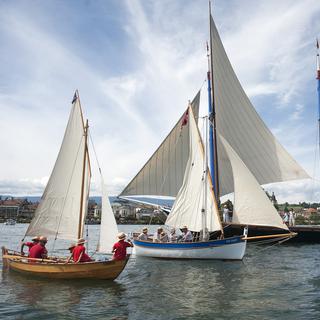 Des barques à voiles naviguent sur lac Léman, lors de la manifestation Voiles latines au large du Vieux Port de Morges. [Keystone - Anthony Anex]