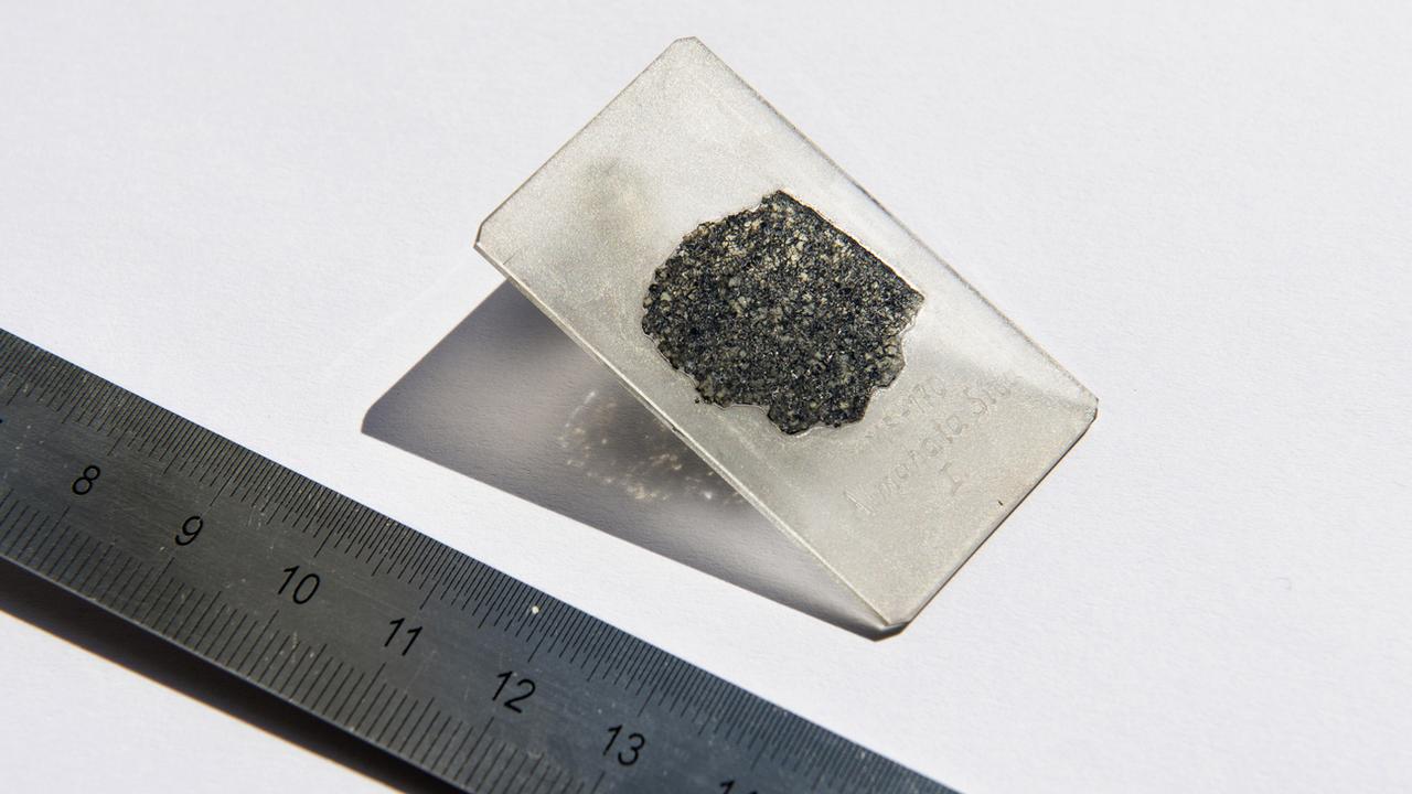 Une tranche de météorite examinée par les scientifiques de l'EPFL. [Keystone - Hillary Sanctuary/EPFL via AP]