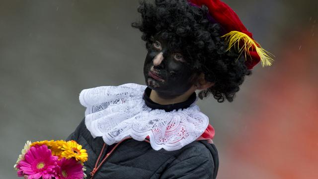 L’assistant de Saint-Nicolas distribue bonbons ou coups de martinet. [AP/Keystone - Peter Dejong]