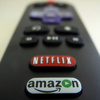 Une télécommande avec les boutons d'accès au service de vidéo à la demande Netflix, et son concurrent Amazon. [Reuters - Mike Blake]