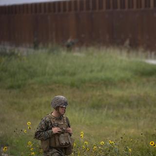 Un soldat américain à côté du mur marquant la frontière entre les USA et le Mexique. [EPA/Keystone - David Maung]