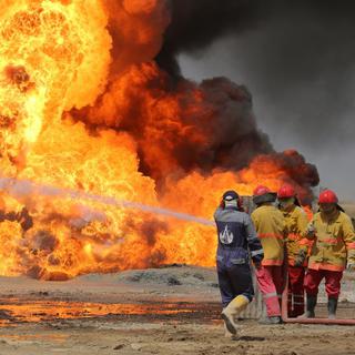 Des incendies provoqués par l'Etat islamique ravagent les terres agricoles en Irak. [EPA-Keystone - DR]