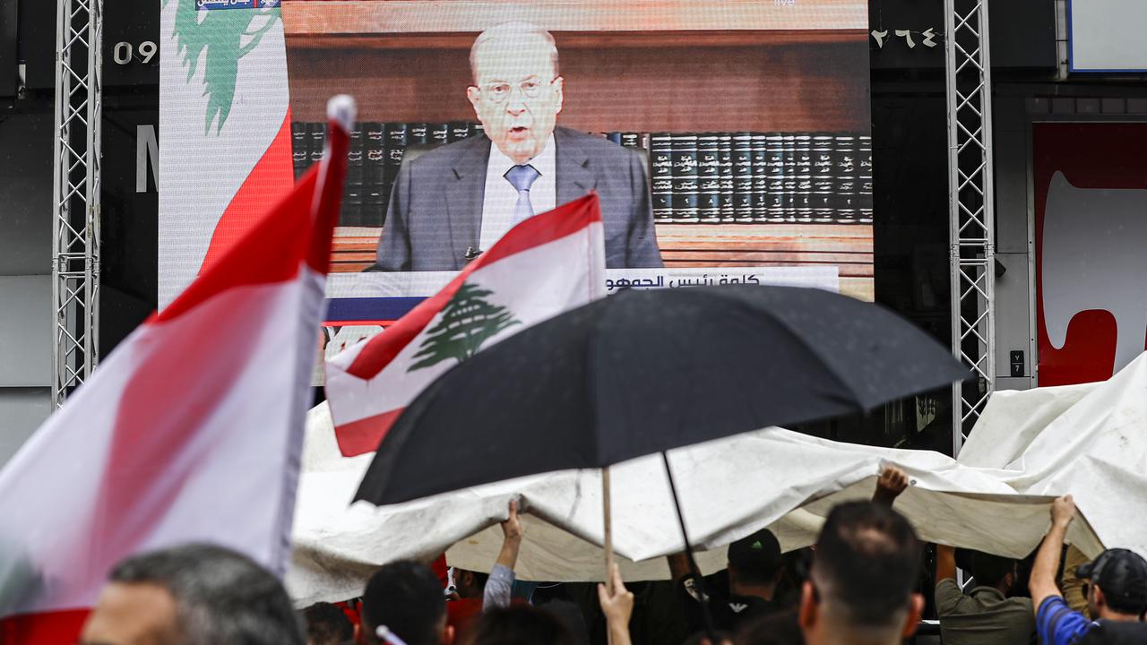 Des manifestants regardent le discours télévisé de Michel Aoun. Il s'agissait de sa première intervention publique après une semaine de soulèvement populaire contre l'ensemble d'une classe politique jugée incompétente et corrompue. [afp - Joseph Eid]