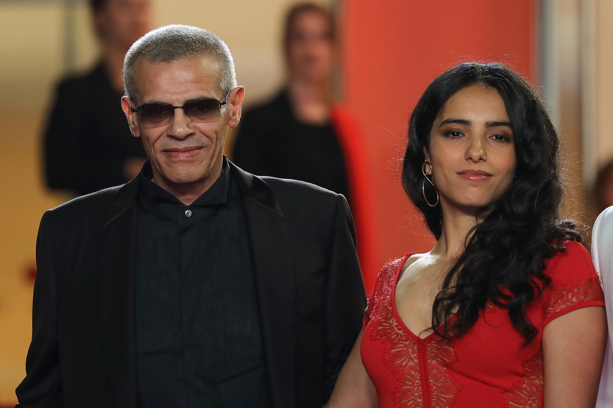 French-Tunisian film director Abdellatif Kechiche and French actress Hafsia Herzi pose as they arrive for the screening of the film "Mektoub, My Love : Intermezzo" at the 72nd edition of the Cannes Film Festival in Cannes, southern France, on May 23, 2019. Valery HACHE / AFP [AFP - Valery HACHE]