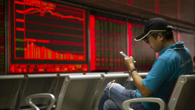Les chinois auraient effectués depuis leur smartphone pour plus de 10'000 milliards CHF de transactions en 2017. [AP - Mark Schiefelbein]