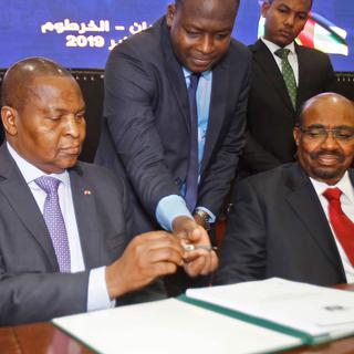 Le président centrafricain lors de la signature sous les yeux du président soudanais à Khartoum. [AFP - Ashraf Shazly]