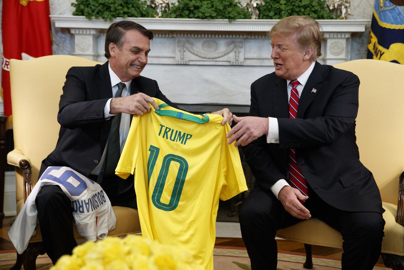Jair Bolsonaro a remis à Donald Trump un maillot de l'équipe brésilienne à son nom lors d'une visite à Washington en mars 2019. [AP/Keystone - Evan Vucci]