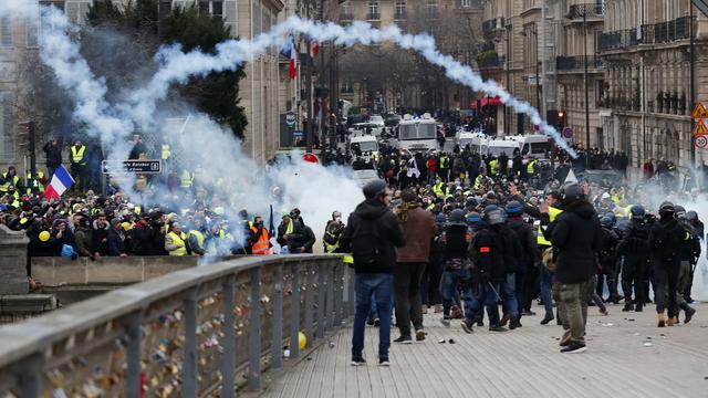 La police lance du gaz lacrymogène sur des protestataires des "gilets jaunes" au bord de la Seine à Paris le 5 janvier 2019. [Keystone - EPA/IAN LANGSDON]