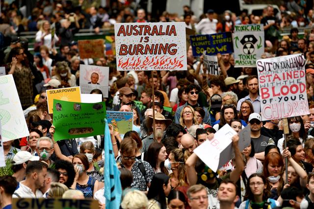 Plus de 20'000 personnes ont manifesté le 11 décembre à Sydney, alors que la qualité de l'air s'est particulièrement déteriorée en raison des incendies aux abords de la ville australienne. [AFP - SAEED KHAN]