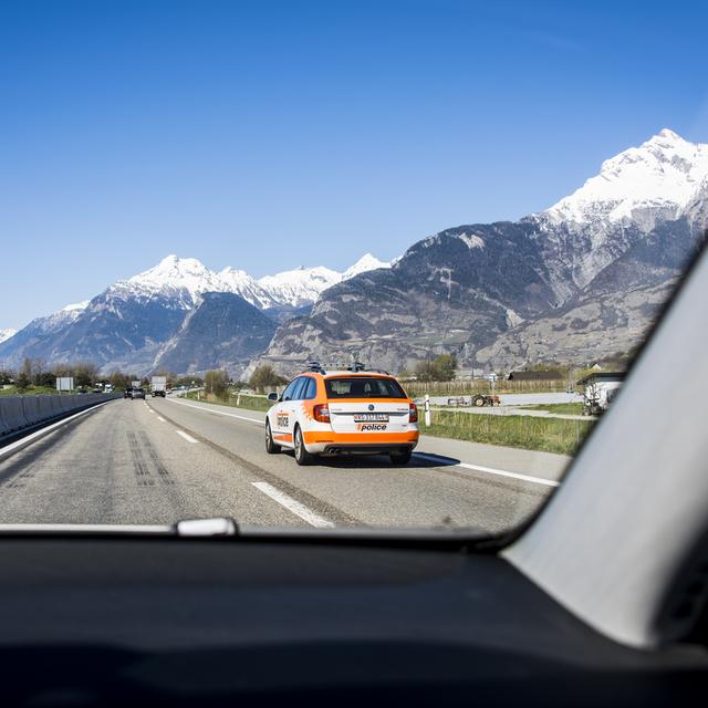 Une voiture de la police valaisanne sur l'autoroute A9 à la hauteur de Sion. [KEYSTONE - OLIVIER MAIRE]