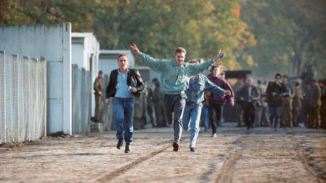 Trois jeunes de Berlin-Est traversent la frontière vers Berlin-Ouest. [Keystone/DPA]