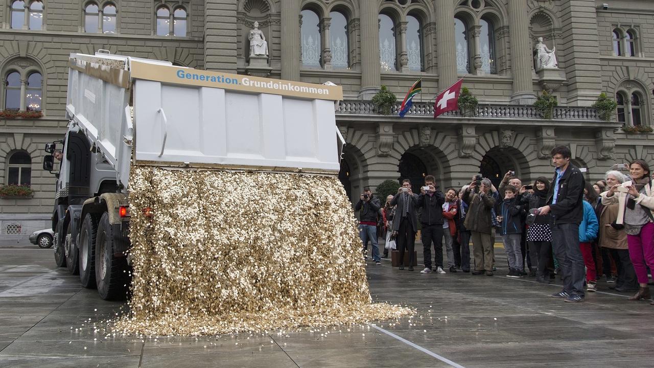 Un camion déverse 8 millions de pièces de 5 centimes sur la Place fédérale lors du dépôt des signatures de l'initiative pour un RBI, en 2013.