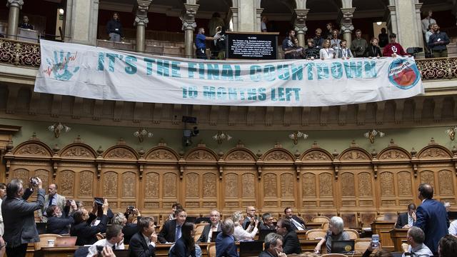 Des manifestants pour le climat ont interrompu une séance de débats au Conseil national. [Keystone - Peter Schneider]