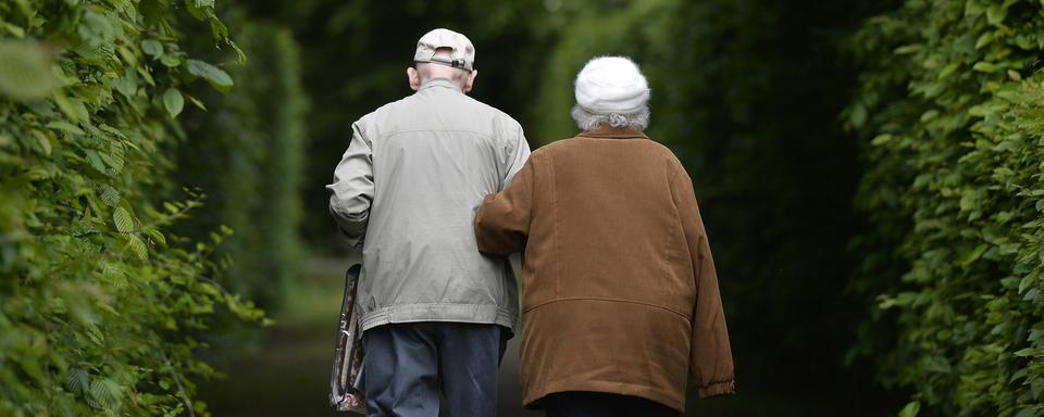 Un couple de personnes âgées en promenade (image d'illustration). [AP Photo/Keystone - Martin Meissner]