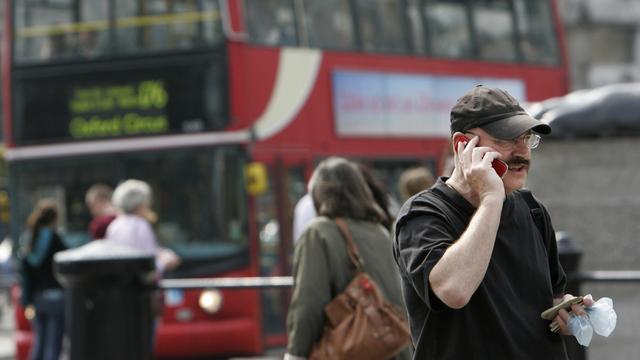 Une personne au téléphone à Trafalgar Square, dans le centre-ville de Londres. (image d'illustration) [Keystone - Lefteris Pitarakis]