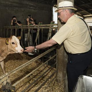 Le Conseiller federal Guy Parmelin a visité trois fermes vaudoises lors de la journée "Portes ouvertes à la ferme". [Keystone - Jean-Christophe Bott]