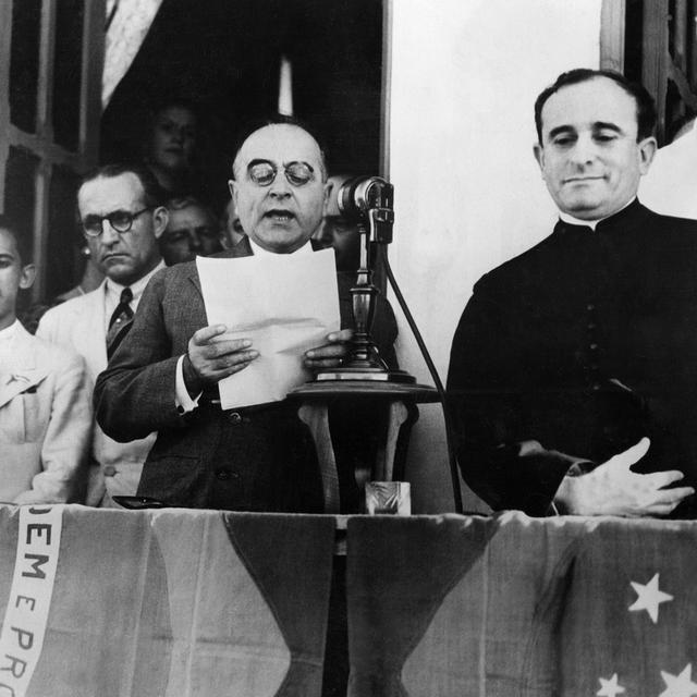 Le 10 novembre 1937, Getulio Vargas annonce la dissolution du congrès brésilien et proclame l'"Estado Novo" d'inspiratino fasciste.
(1883-1954), President of Brazil, delivers a broadcast speech to announce the dissolution of congress and to proclame the fascist "Estado Novo" ("New State") dictatorship, 10 November 1937 in Rio de Janeiro. Elected Federal deputy since 1923, Getulio Vargas seized power by revolution in 1930. From 1937, as he dissolved congress and suppressed all political parties and trade unions, he governed as a populist dictator. In 1945 he was ousted by popular clamour for a democratic constitution, but was voted back to office in 1951. Four years later, in face of mounting opposition, he committed suicide. 
AFP [AFP]
