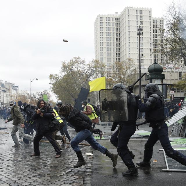 Des policiers confrontés à des manifestants à Paris. [Keystone/EPA - Yoan Valat]
