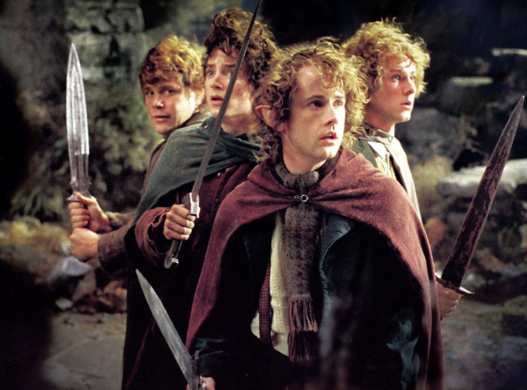 Elijah Wood, Sean Astin, Billy Boyd, Dominic Monaghan jouent des Hobbits dans "Le Seigneur des Anneaux" en 2001. [AFP - Archives du 7eme Art / Photo12]