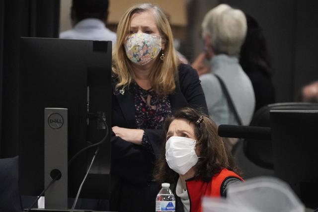 Des représentants démocrates et républicains examinent les bulletins de vote envoyé par la poste, au centre de préparation des élections du comté de Fulton. Atlanta, le 4 novembre 2020. [Keystone/AP photo - John Bazemore]