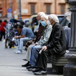Des retraités sur un banc. [Keystone - EPA/Riccardo Antimiani]