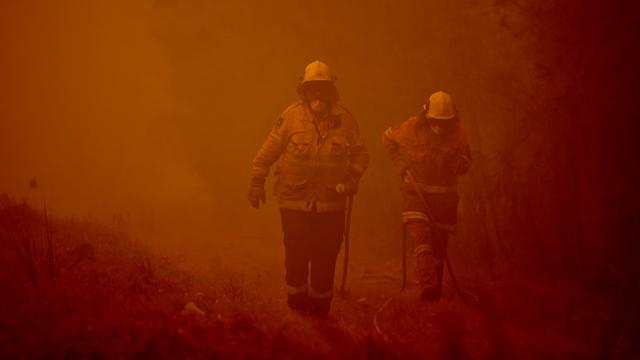 Des pompiers australiens tentent de circonscrire les feux. [AFP - Peter Parks]