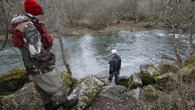 Des pêcheurs au bord de la rivière de l'Allandon, à Dardagny près de Genève. [Keystone - Salvatore Di Nolfi]