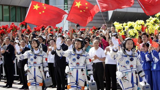 Trois "taïkonautes" chinois, dont la première femme, saluent la foule avant le lancement d'une fusée Shenzhou 9, en 2012. [Reuters - Jason Lee]