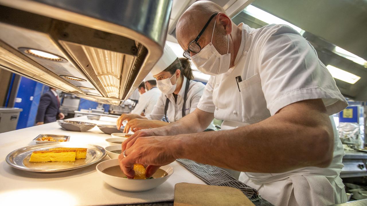 Le chef Philippe Chevrier et son équipe, portant des masques, le 12 mai 2020 dans les cuisines du restaurant de Satigny (GE). [Keystone - Salvatore Di Nolfi]