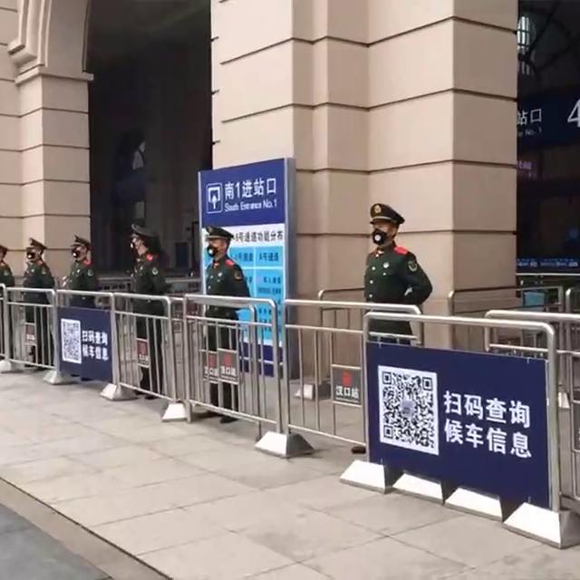 23 janvier: l'entrée de la gare de Wuhan bloquée par des policiers, alors que la ville de 11 millions d'habitants a été placée en quarantaine. [Keystone - The Paper via AP]
