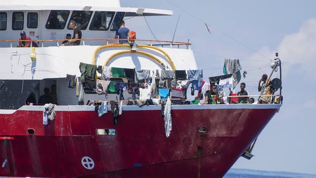 Les migrants étaient bloqués à bord de bateaux de tourisme mobilisés pour l'occasion. [AP/Keystone - René Rossignaud]