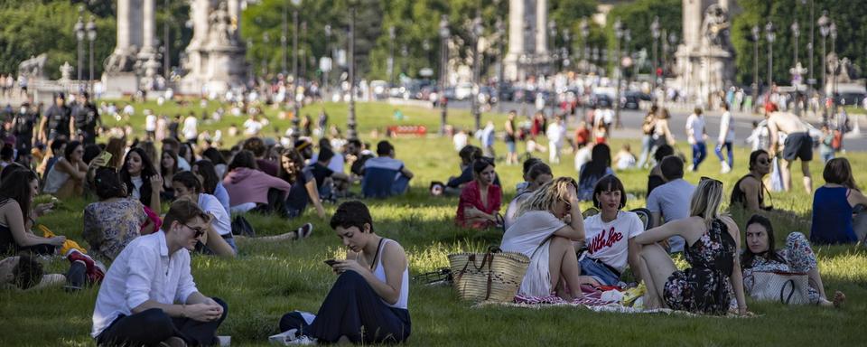 Des Parisiens profitent du beau tremps sur l'esplanade des Invalides à Paris, le 21 mai 2020. [EPA/Keystone - Ian Langsdon]