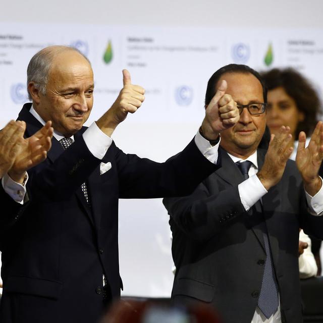 French foreign minister and President of the COP21 Laurent Fabius, center, applauds while United Nations Secretary General Ban Ki-moon, left, and French President Francois Hiollande applaud after the final conference of the COP21, the United Nations conference on climate change, in Le Bourget, north of Paris, Saturday, Dec.12, 2015. Nearly 200 nations adopted the first global pact to fight climate change on Saturday, calling on the world to collectively cut and then eliminate greenhouse gas pollution but imposing no sanctions on countries that don't. (AP Photo/Francois Mori) [AP - François Mori]