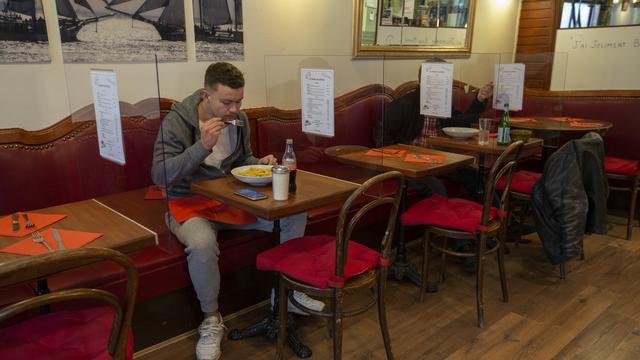 Un client mange à une table d'un restaurant genevois, le 13 mai 2020. [Keystone - Salvatore Di Nolfi]