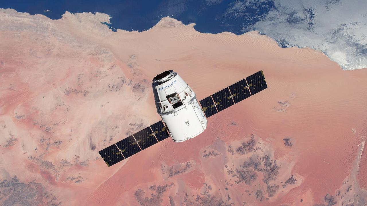 Le vaisseau spatial Dragon de SpaceX, avec ses panneaux solaires déployés, amène du matériel à la station ISS pour la NASA. [SpaceX]