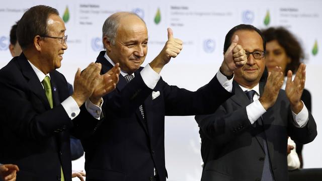 French foreign minister and President of the COP21 Laurent Fabius, center, applauds while United Nations Secretary General Ban Ki-moon, left, and French President Francois Hiollande applaud after the final conference of the COP21, the United Nations conference on climate change, in Le Bourget, north of Paris, Saturday, Dec.12, 2015. Nearly 200 nations adopted the first global pact to fight climate change on Saturday, calling on the world to collectively cut and then eliminate greenhouse gas pollution but imposing no sanctions on countries that don't. (AP Photo/Francois Mori) [AP - François Mori]