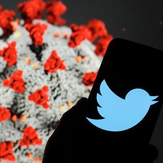 POLAND - 2020/03/13: In this photo illustration a Twitter logo seen displayed on a smartphone. The computer model of the COVID-19 coronavirus is displayed as the background. (Photo Illustration by Filip Radwanski/SOPA Images/LightRocket via Getty Images) [Getty Images - Filip Radwanski/SOPA Images/LightRocket]