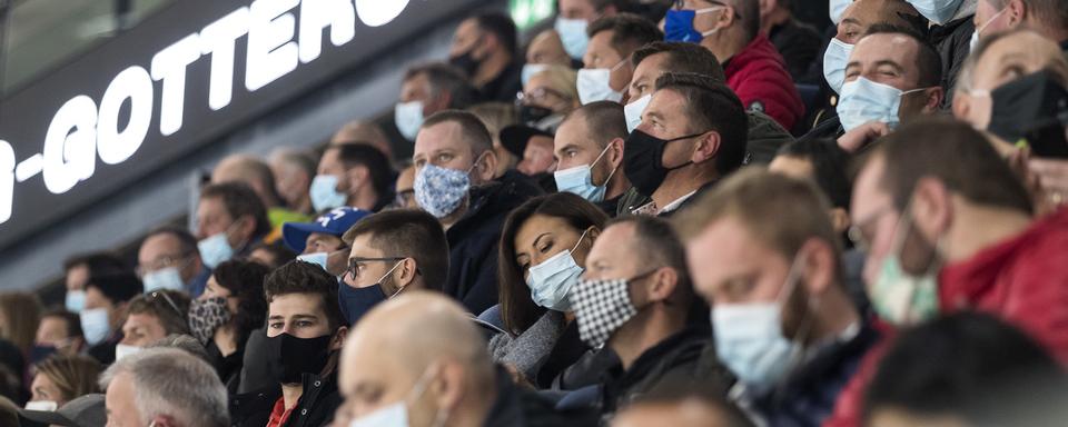 Tous les spectateurs portent un masque lors du match du championnat suisse de hockey sur glace de National League, NL, entre HC Fribourg-Gottéron, et SC Rapperswil-Jona Lakers, le 1er octobre 2020  à Fribourg. [Keystone - Cyril Zingaro]