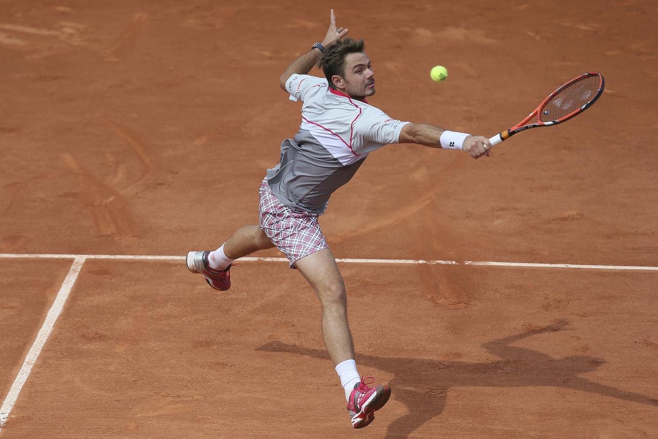 Stan Wawrinka dans ses oeuvres et en promenade face à Steve Johnson. [AFP - David Vincent]