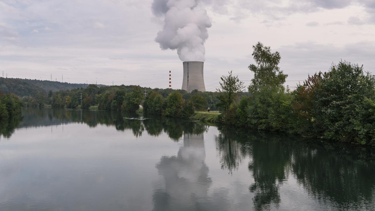 Des volutes de vapeur d'eau se dégagent de la tour de refroidissement de la centrale nucléaire de Gösgen (SO), située au bord de l'Aar. [Keystone - Christian Beutler]