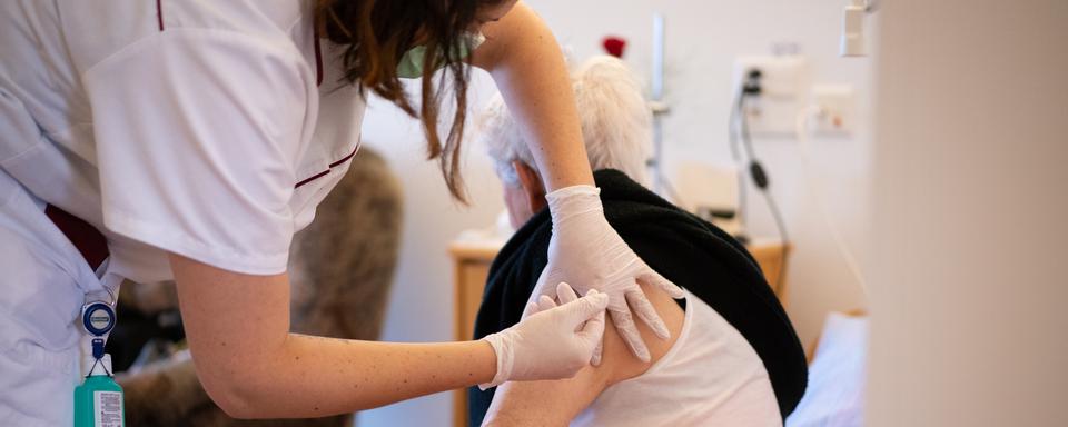 Une membre du personnel de la Résidence Claire-Fontaine à Bassecourt (JU) administre le vaccin anti-Covid à une résidente. [DR - Jura.ch]