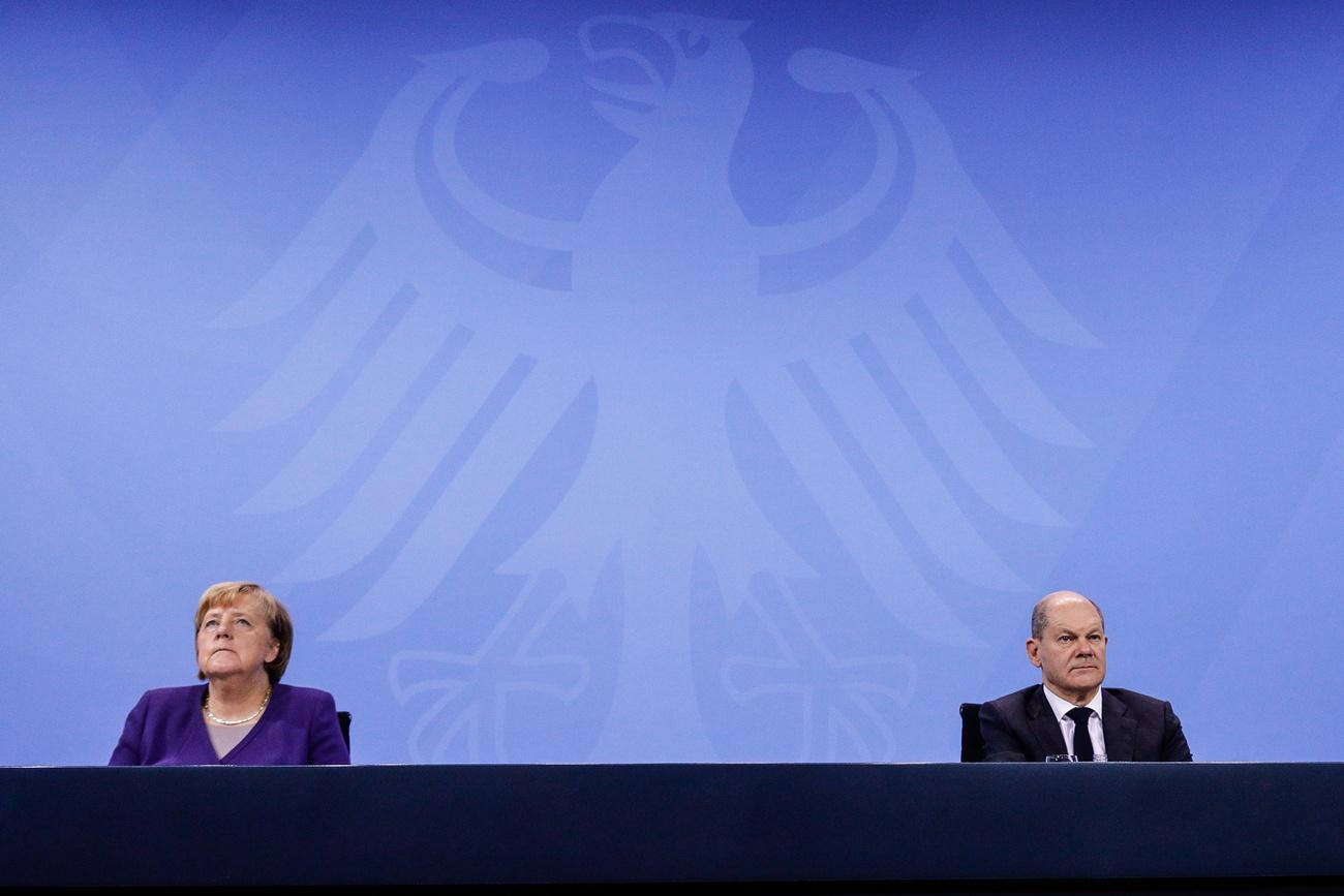 La Chancelière allemande Angela Merkel, son successeur Olaf Scholz, et les représentants des 16 Länder allemands ont annoncé un durcissement des mesures anti-Covid. [Keystone - Filip Singer]