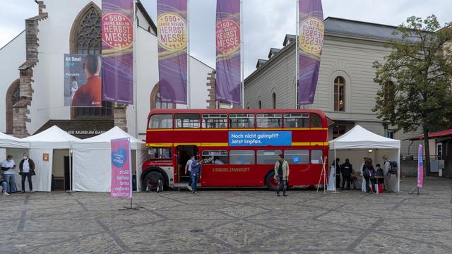 Le bus de vaccination se tient prêt sur la Barfuesserplatz à Bâle, lundi 20 septembre 2021. À partir du 13 septembre 2021, un bus de vaccination circulera pendant quatre semaines dans le canton de Bâle-Ville, où le public pourra se faire vacciner spontanément contre le coronavirus sans avoir à prendre rendez-vous au préalable. [KEYSTONE - Georgios Kefalas]