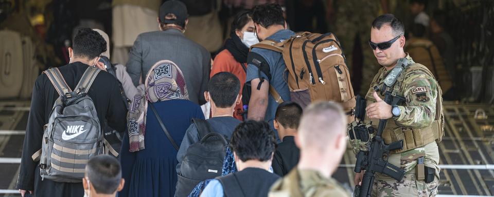 Des personnes sont évacuées par les forces américaines. Aéroport Hamid Karzai, Kaboul, le 24 août 2021. [Keystone/AP - Senior Airman Taylor Crul/U.S. Air Force]