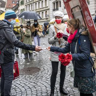 La municipale socialiste Florence Germond et la candidate Emilie Moeschler en campagne sur le marché de la Palud à Lausanne, le 12 décembre 2020. [Keystone - Jean-Christophe Bott]